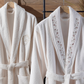 Cream-ecru women`s bathrobe decorated with tiny floral embroideries