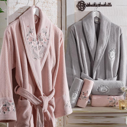 Bathroom designed with  powder-pink, cotton women`s robe and grey men`s robe 