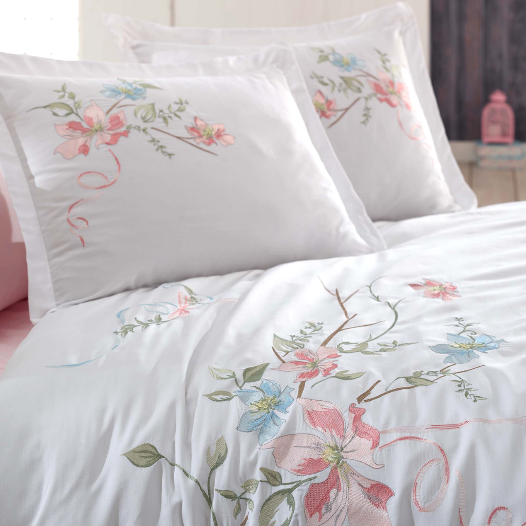 Pink and blue daffodil flowers are embroidered on white, cotton-sateen duvet cover and pillowcases