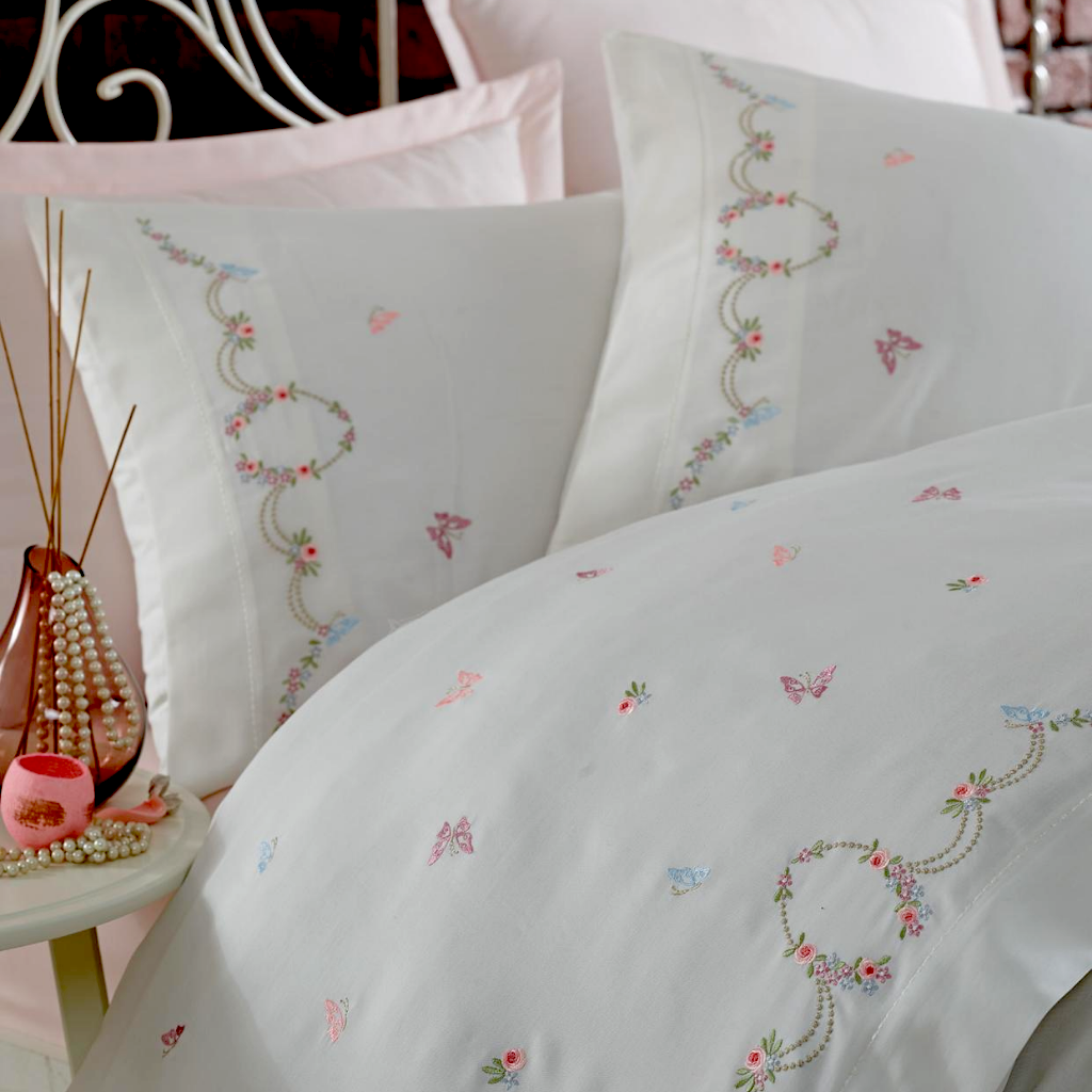 Pink, blue, green flower and butterfly embroideries combines with pink bed sheet