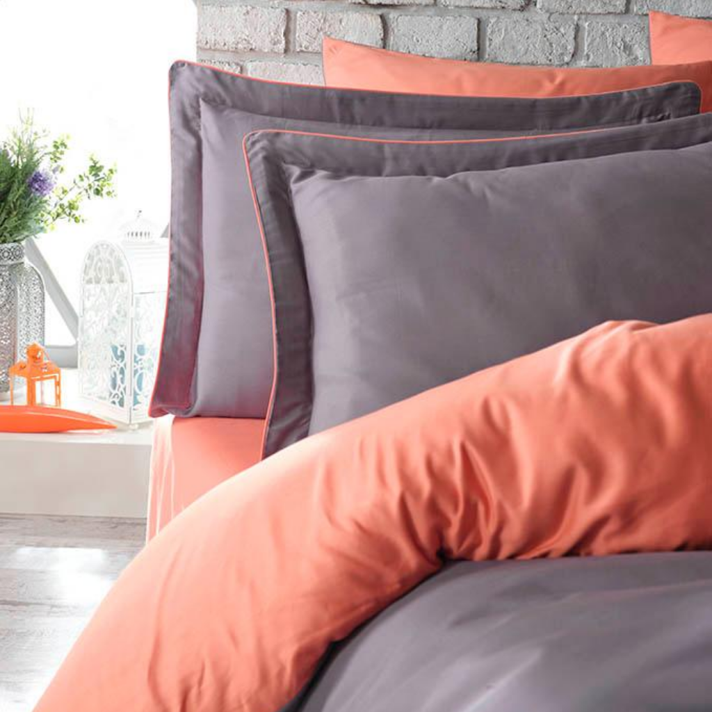 Cotton duvet cover is orange color on one side and grey color on the other side