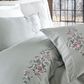 Maldive-blue quilt cover and pillowcases ornamented with bordeaux and grey floral patterns