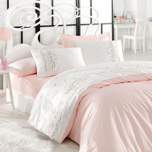 White bedroom decorated with pink-white, cotton-sateen bedding set.