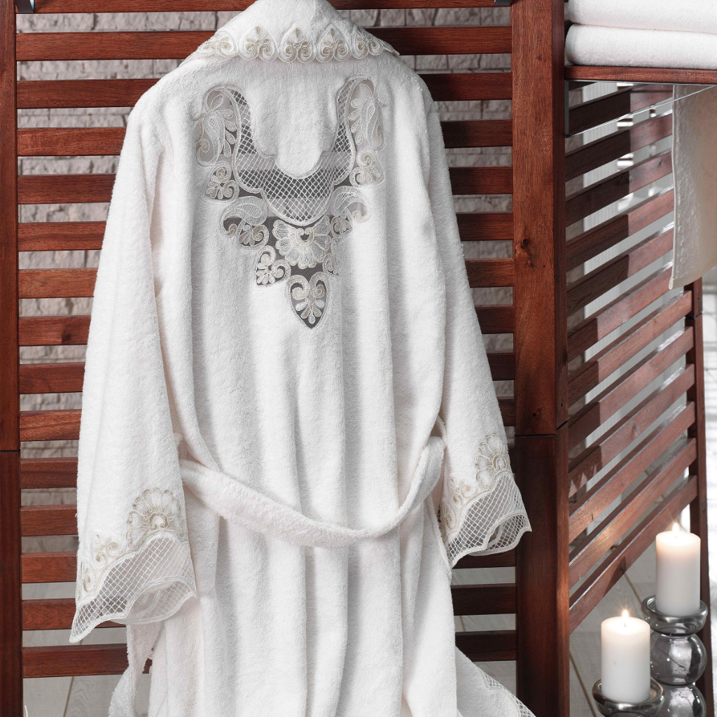 Collar, cuffs and back of cotton women`s robe is ornamented with heart-shape lace