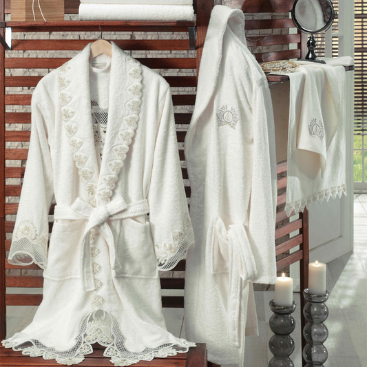Romantic bathroom decorated with candles and bathrobe which has heart-shaped guipure and lace ornaments