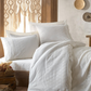 Traditional Turkish bedroom decorated with pure white, bride`s selection bed linen set which is ornamented with delicate lace 