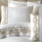 Borders of white duvet cover and shams are designed with delicate, bronze color guipure