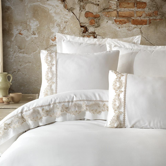 Classic style bedroom decorated with white bed linen set ornamented with bronze guipure