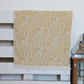 Mustard color, soft Turkish beach towel has fish designs