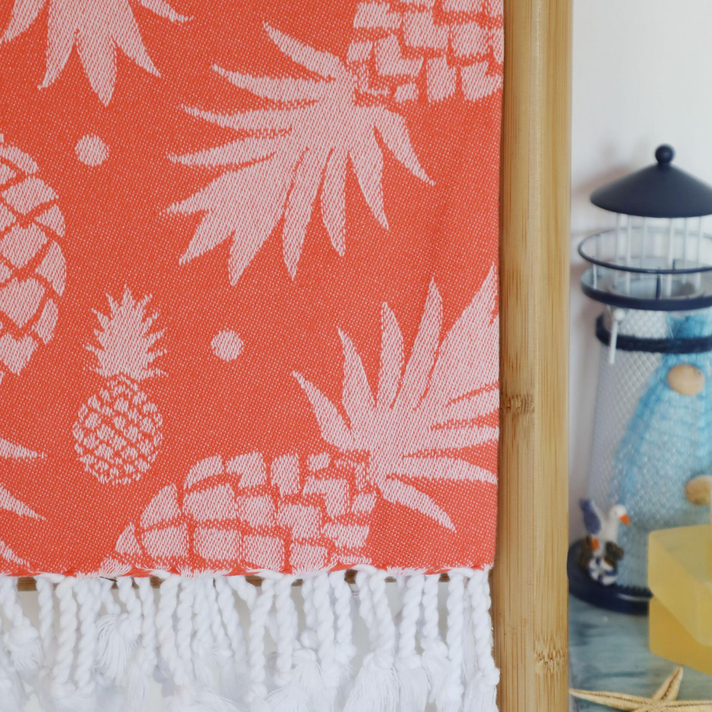 coral collar Turkish beach towel with pineapple designs on it