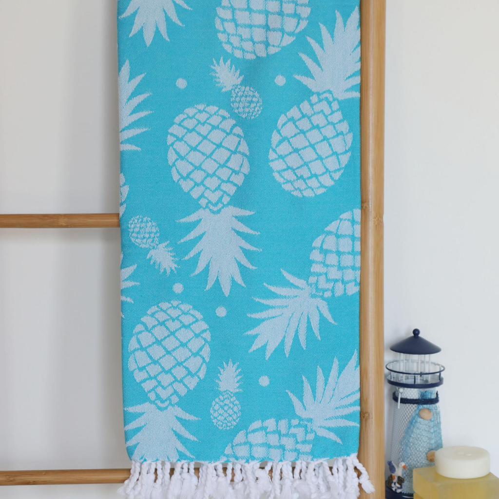 Bright blue color Turkish beach towel has pineapple design