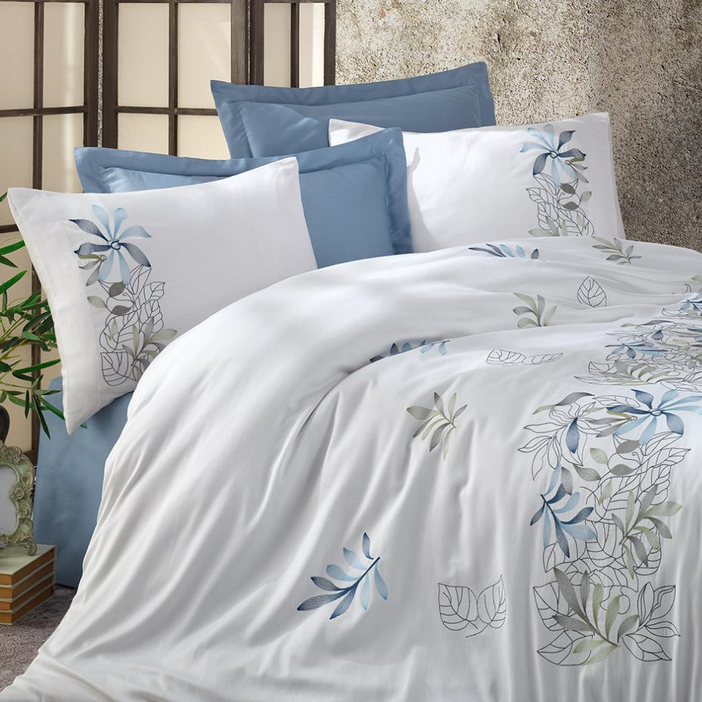 Blue floral designs embroidered on white, cotton-sateen bed linen 